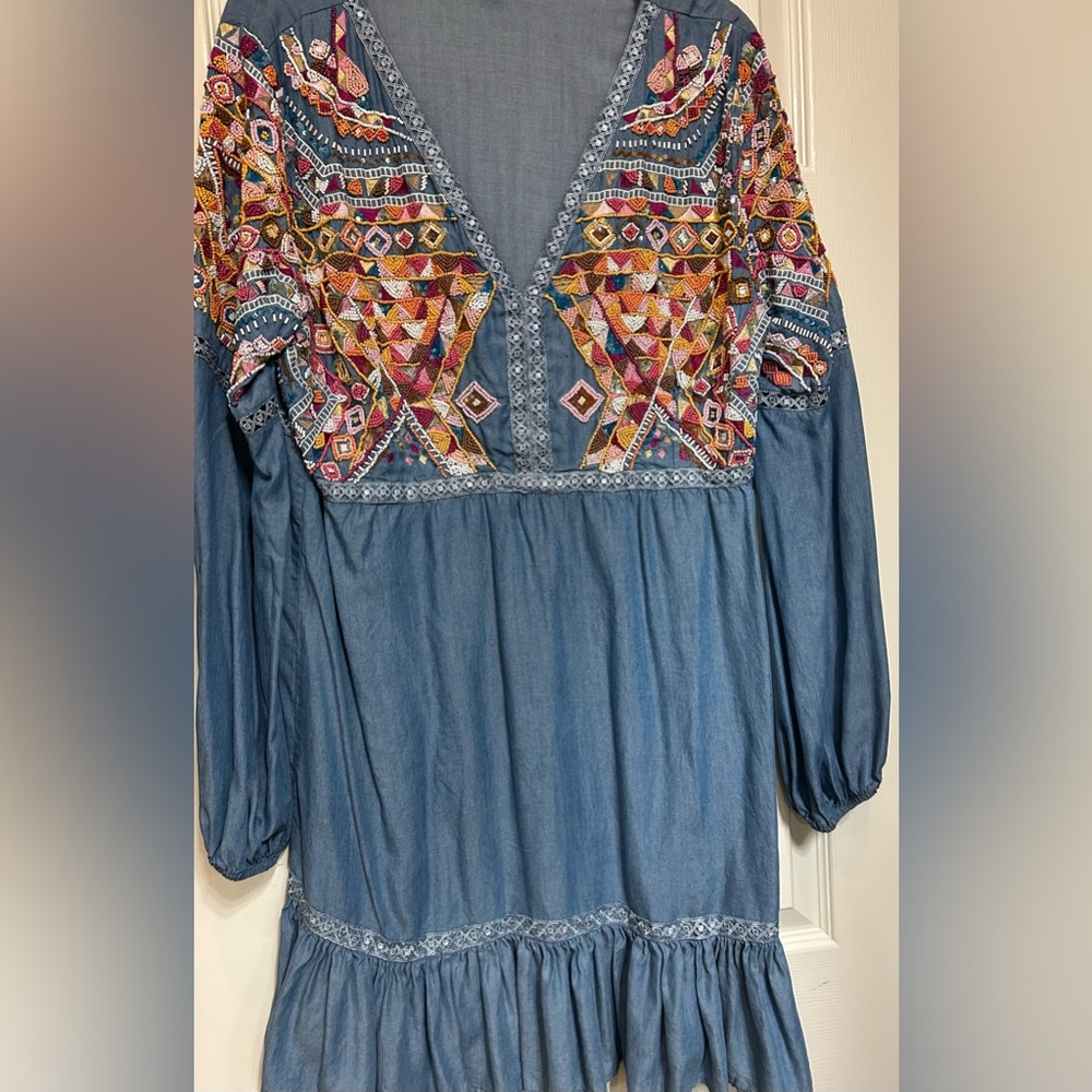 Beaded chambray dress with bitten ruffle abs detail.